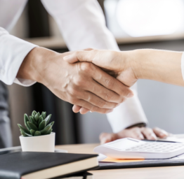 Business executives shaking hands after meeting at office, colleagues management